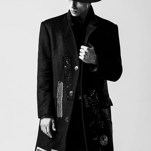 fashionable man wearing a coat and hat