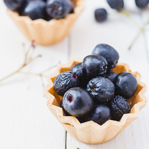 close up of blueberries in a tart crust